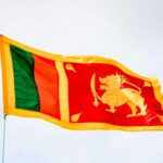 Vibrant Sri Lankan flag fluttering in the breeze on a clear day, symbolizing national pride.